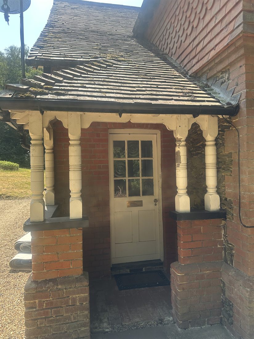 Columned porch with glazed entrance door