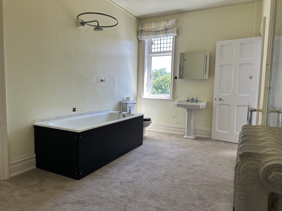 Period bathroom with bath and leaded window